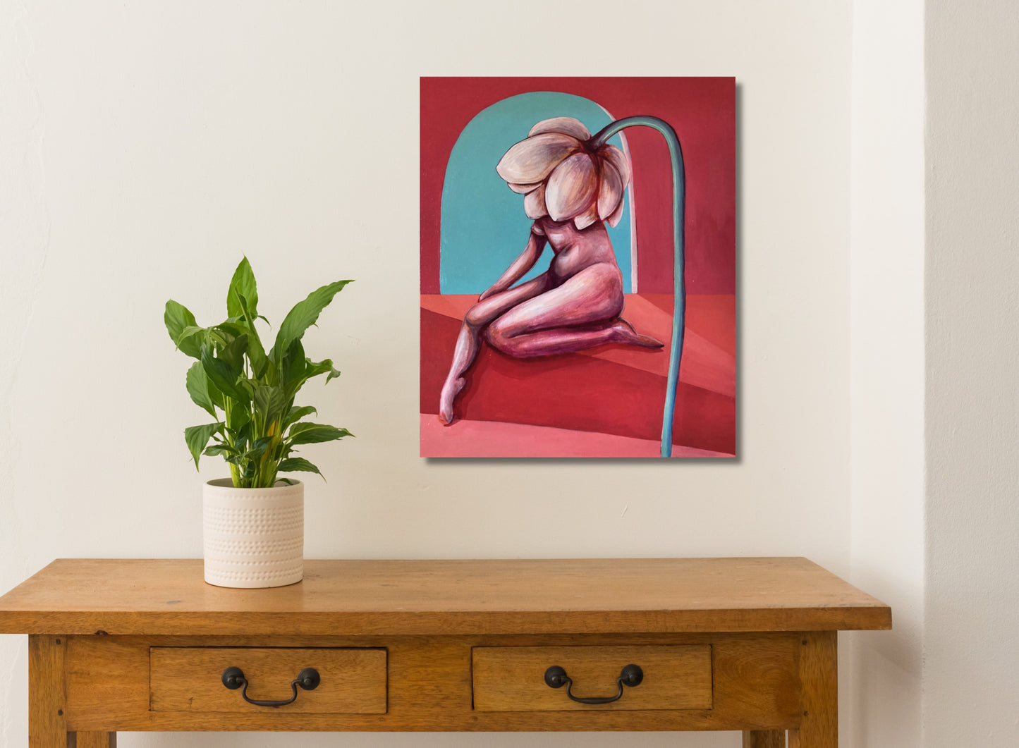 An oil painting on linen, depicting a nude figure with a large flower-like growth on the back, with a red and blue abstract background. white wall, table and plant