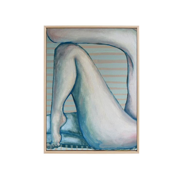 A framed art print featuring a stylized painting of a seated figure in shades of blue, gray, and white, set against a light wood frame on a solid white background.