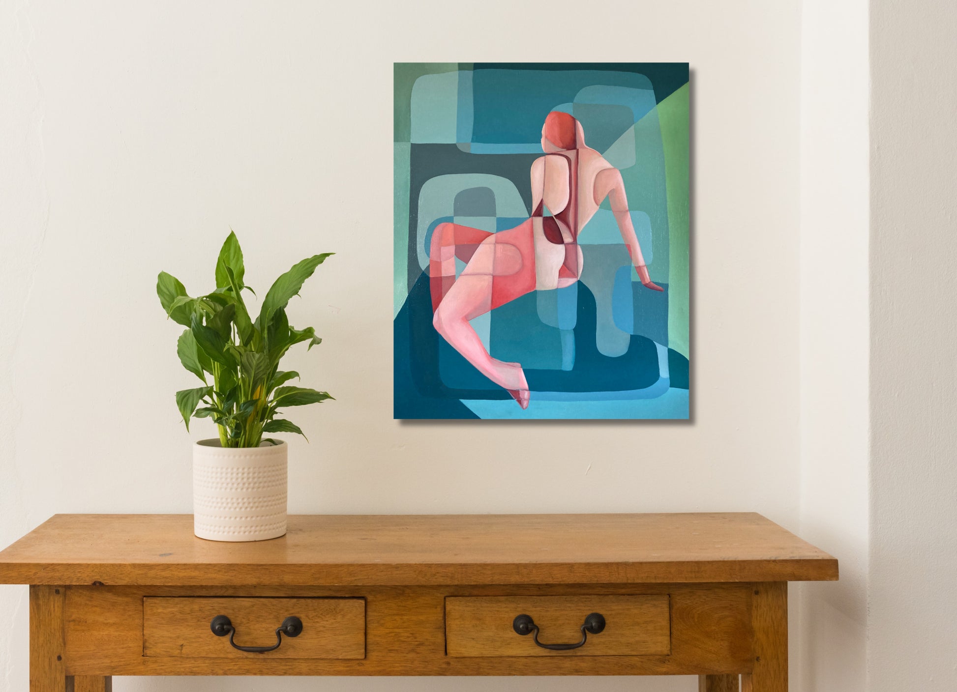 An abstract oil painting on linen, depicting a figure in a red and white pose against a blue and green background by Australian Artist Michelle Macnamara, hanging on a white wall