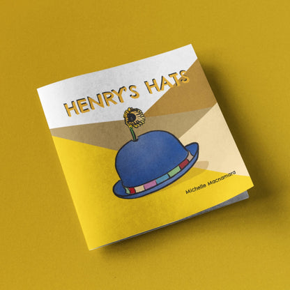Henry’s Hats, paperback childrens book with a blue hat on a yellow background 